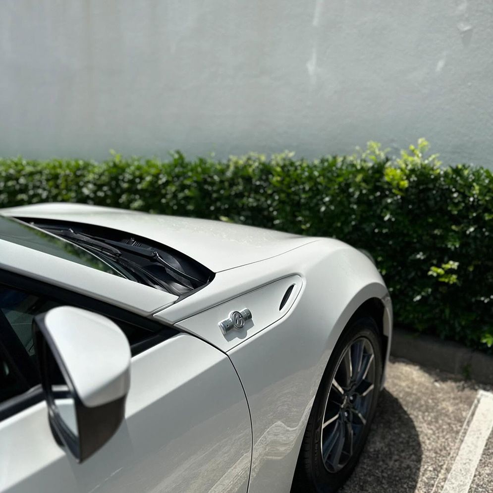 A White Sports Car Is Parked In A Parking Lot — Remedy Mobile Car Detailing in Currumbin, QLD
