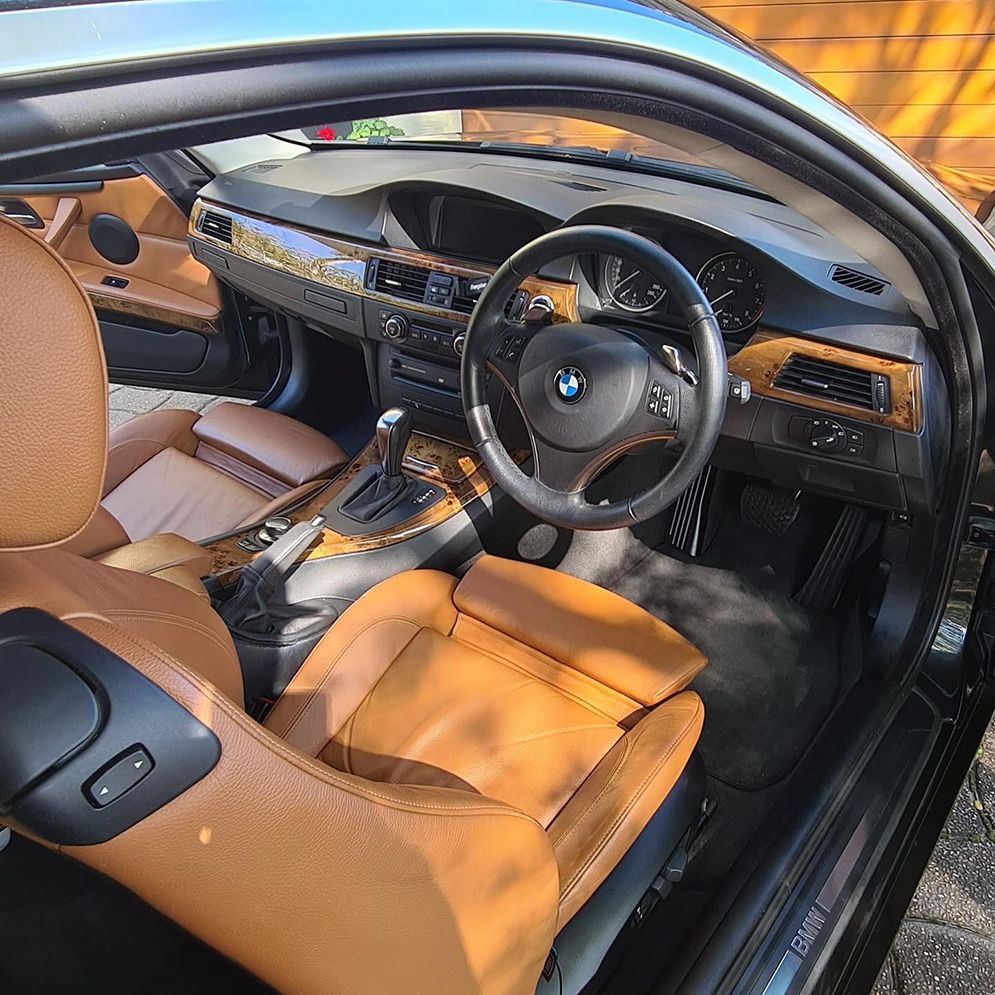 The Interior Of A Black Bmw With Brown Seats And A Steering Wheel — Remedy Mobile Car Detailing in Kingscliff, NSW