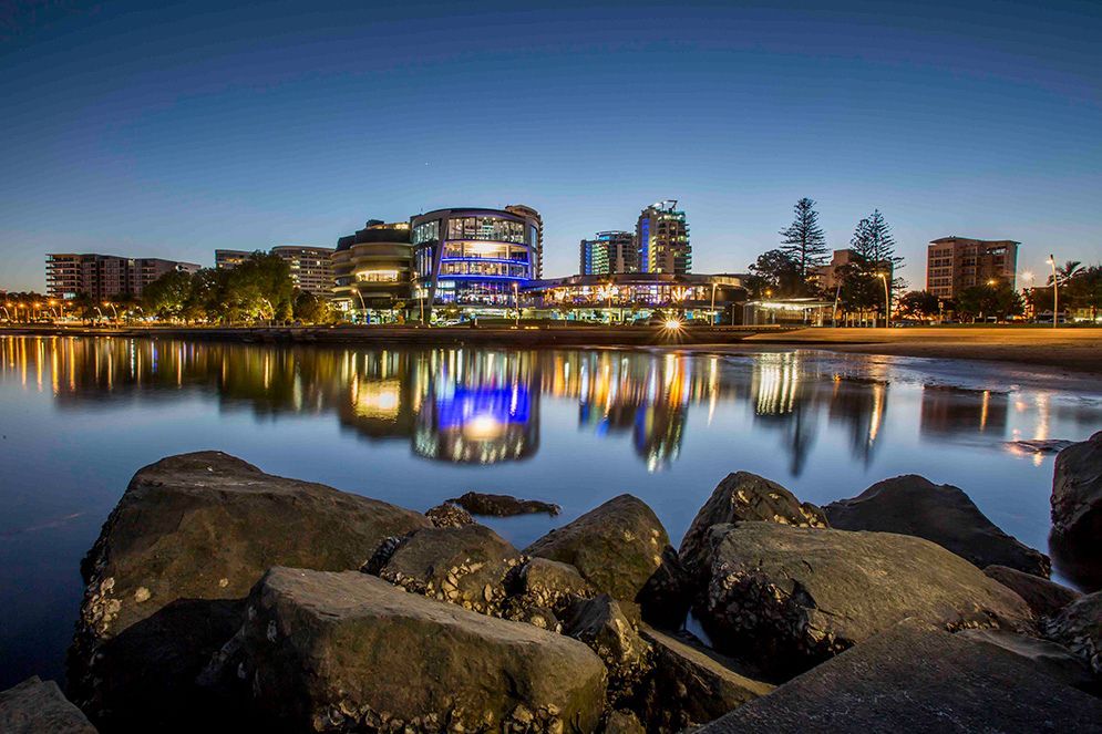 A City Is Reflected In The Water Of A Lake At Night — Remedy Mobile Car Detailing in Tweed Heads, NSW