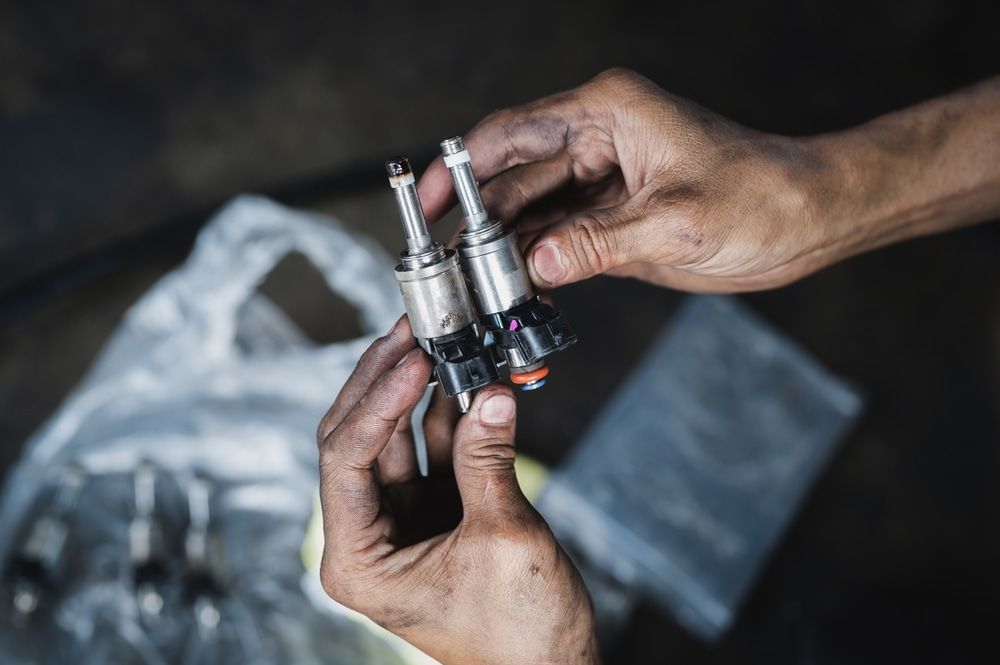 A Person is Holding Two Fuel Injectors in Their Hands — ANI Automotive in Long Jetty, NSW