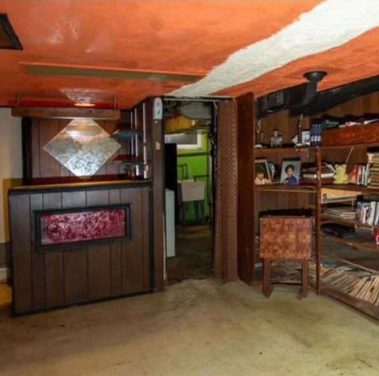 A room with a red ceiling and wooden walls