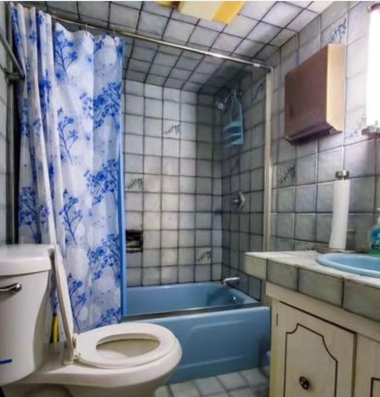 A bathroom with a toilet a sink and a bathtub