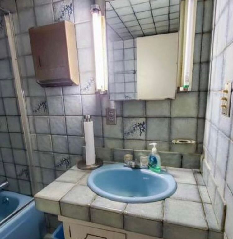 A bathroom with a sink and a mirror