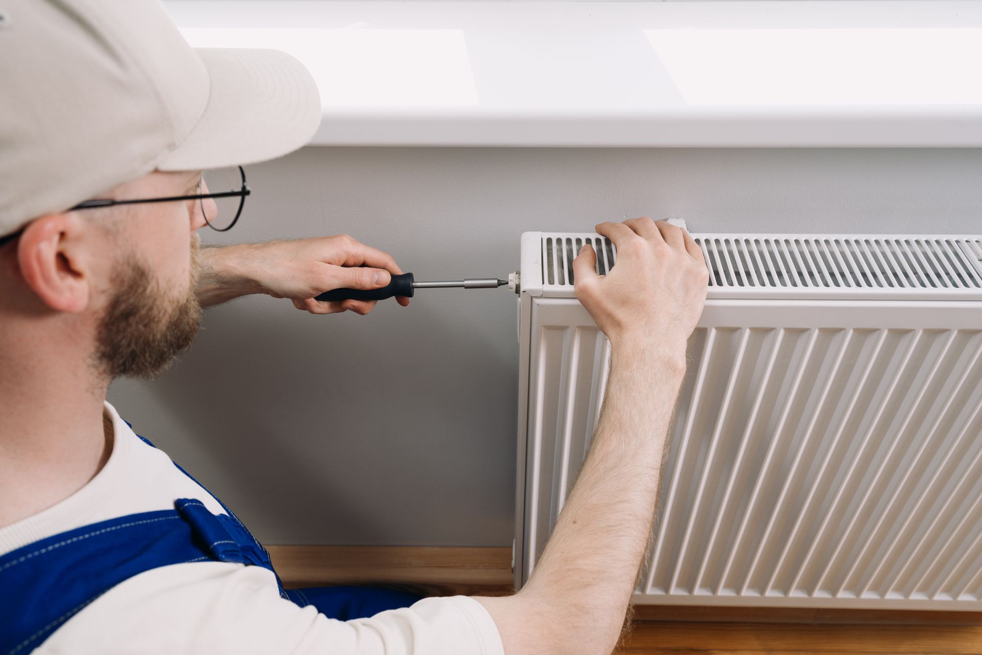 Technician performs heating system maintenance