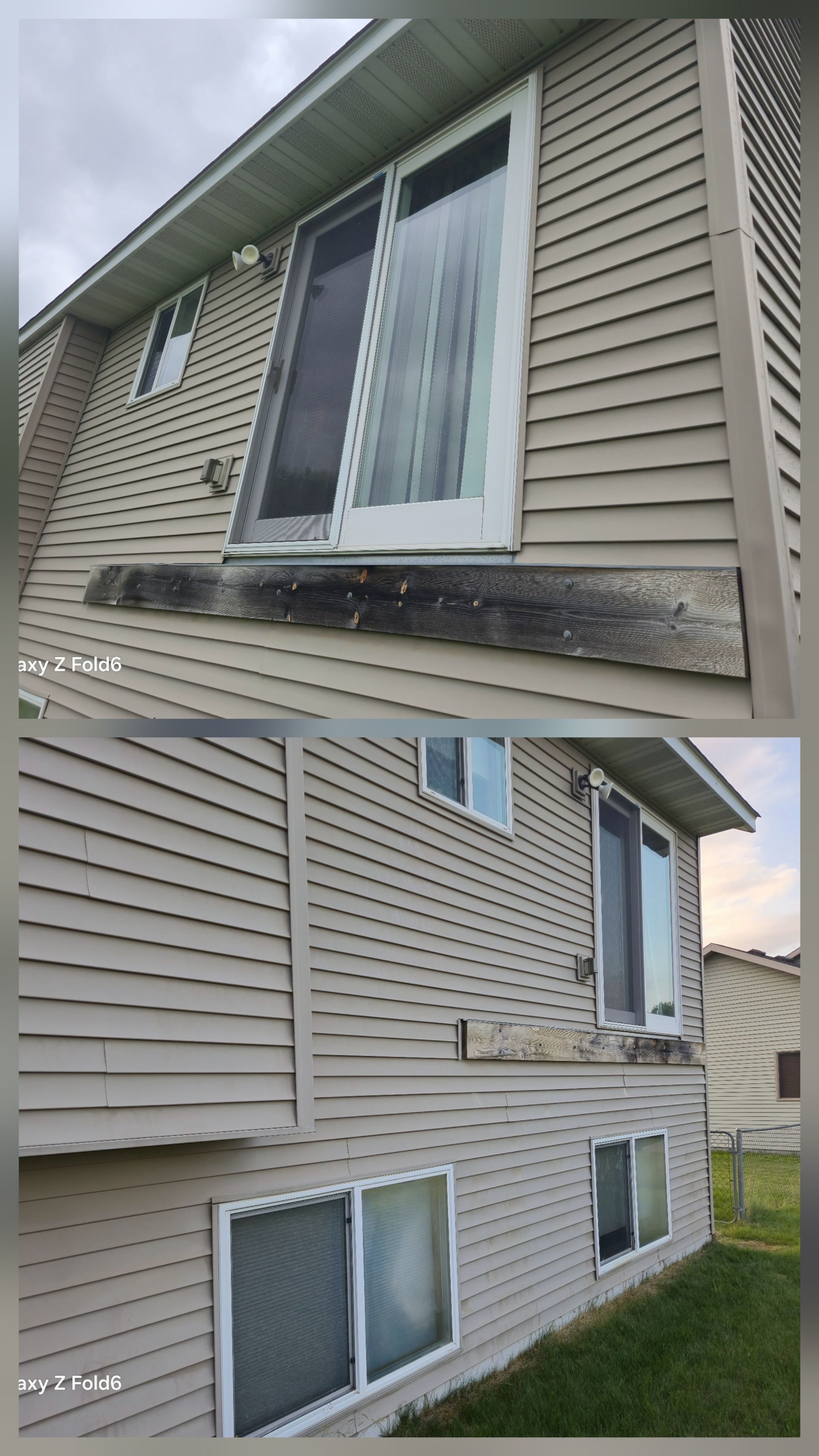 A two-story beige house with a sliding glass door and windows. The exterior shows signs of weathering and algae buildup.