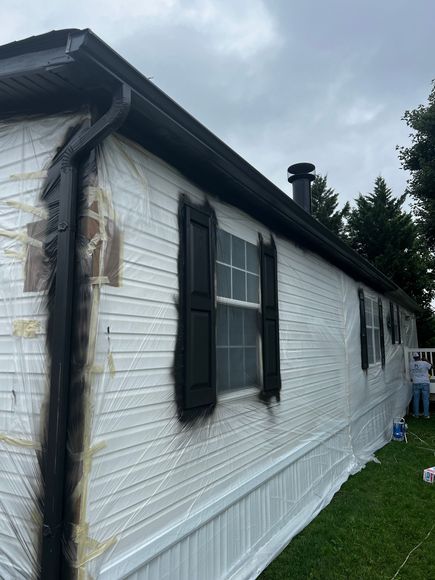 White kitchen cabinetry with glass doors, a wine rack, and granite countertops situated next to a window with blinds.