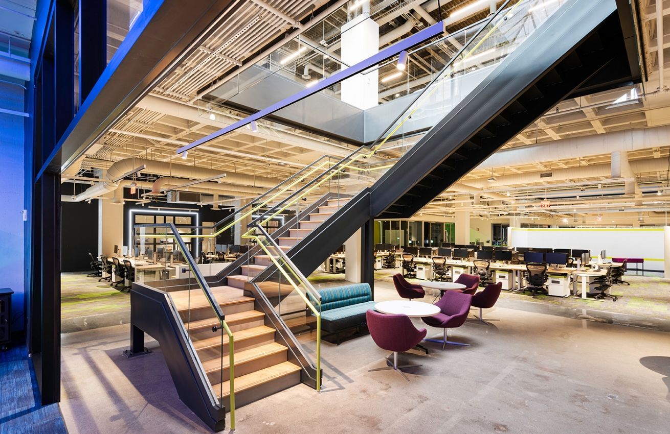 A large office building with stairs leading up to the second floor.