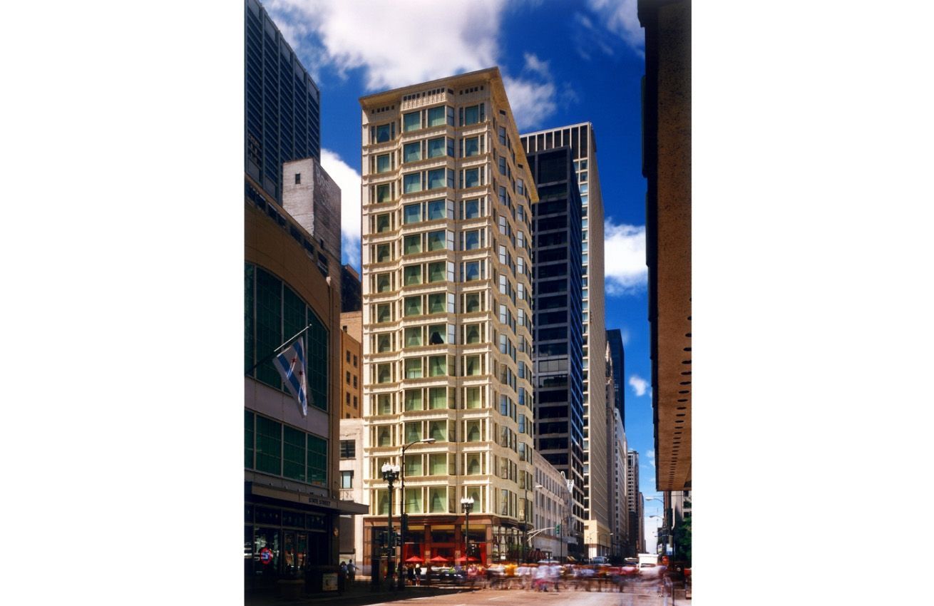 A busy city street with a tall building in the middle