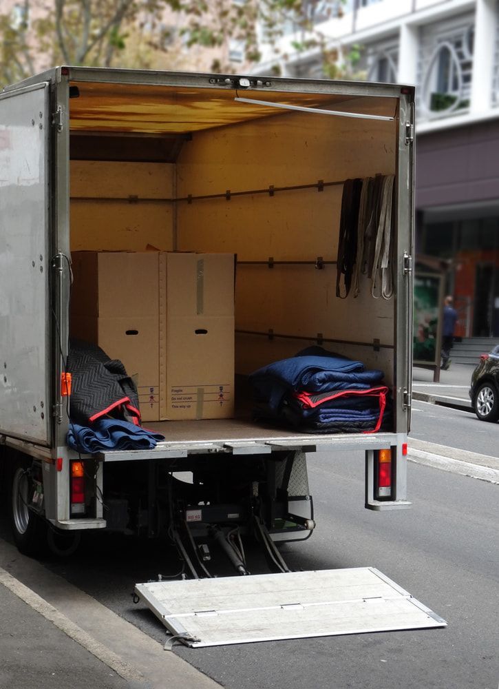 A Moving Truck Is Parked On The Side Of The Road With The Back Door Open — Removalists In Ballina