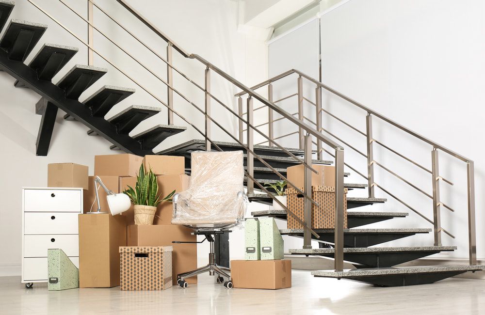 A Room With Stairs And Boxes On The Floor — Removalists In Ballina