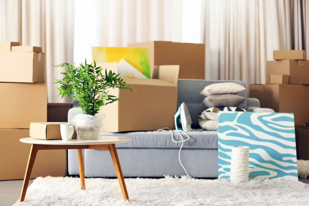 A Living Room Filled With Cardboard Boxes And A Chair — Removalists On The Gold Coast
