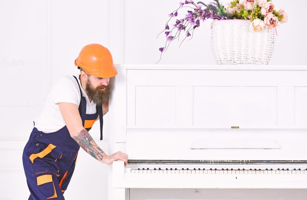 Removalist Relocating a White Piano