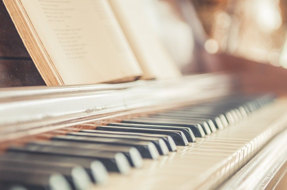 A Close Up Of A Piano Keyboard With A Book On Top Of It — Removalists In Lismore