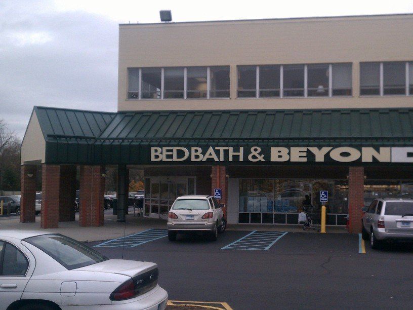 a bed bath and beyond store with cars parked outside