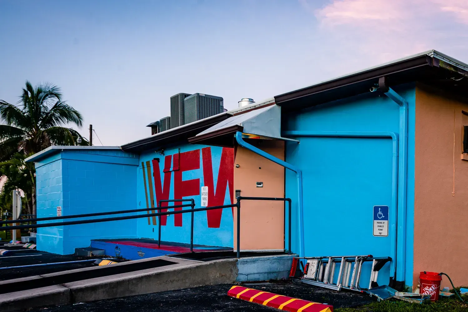 A blue building with the word new painted on it