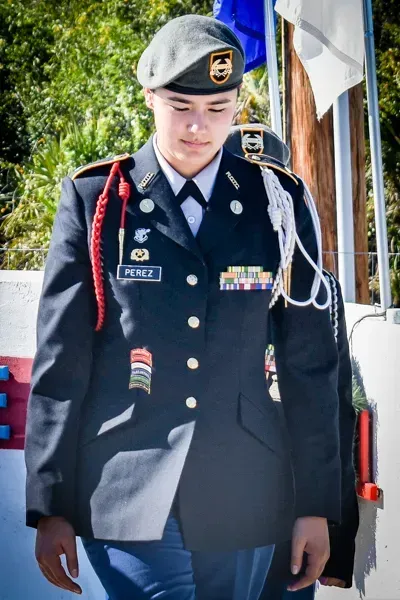 A woman in a military uniform with the name andz on it
