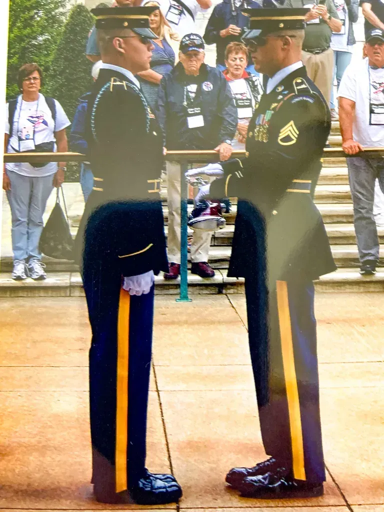 Two men in military uniforms are standing next to each other