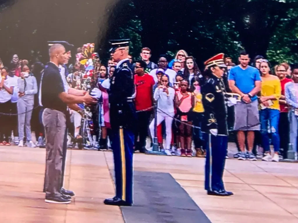 Two soldiers stand in front of a crowd of people