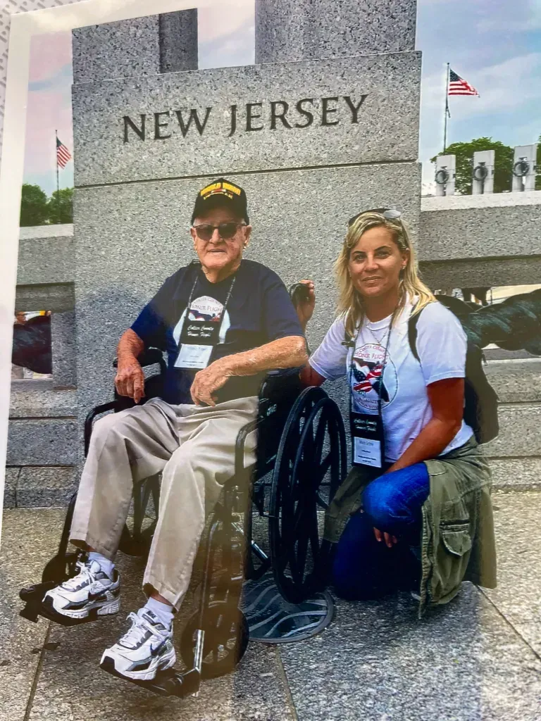 A man in a wheelchair is sitting next to a woman.