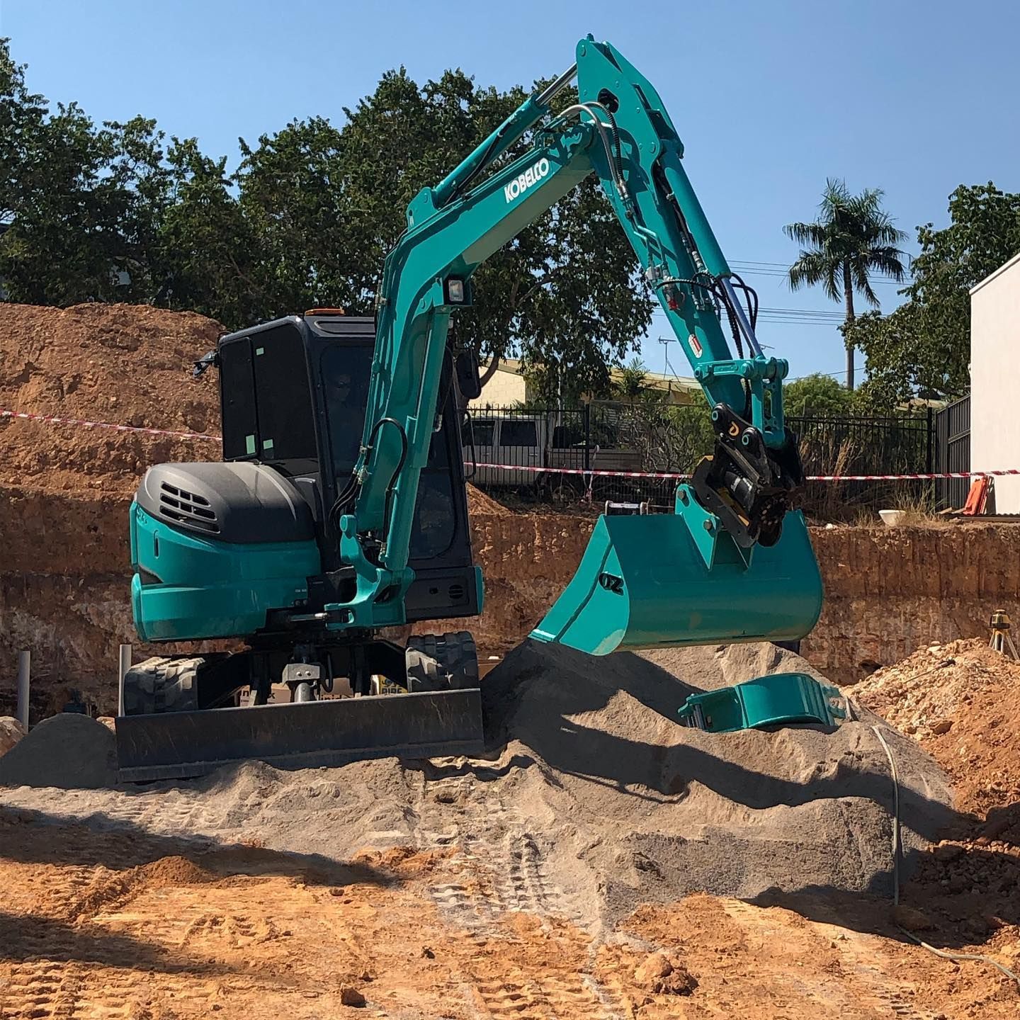 Teal Excavator Digging in A Construction Site with Dirt — Forecast Machinery in Yarrawonga, NT