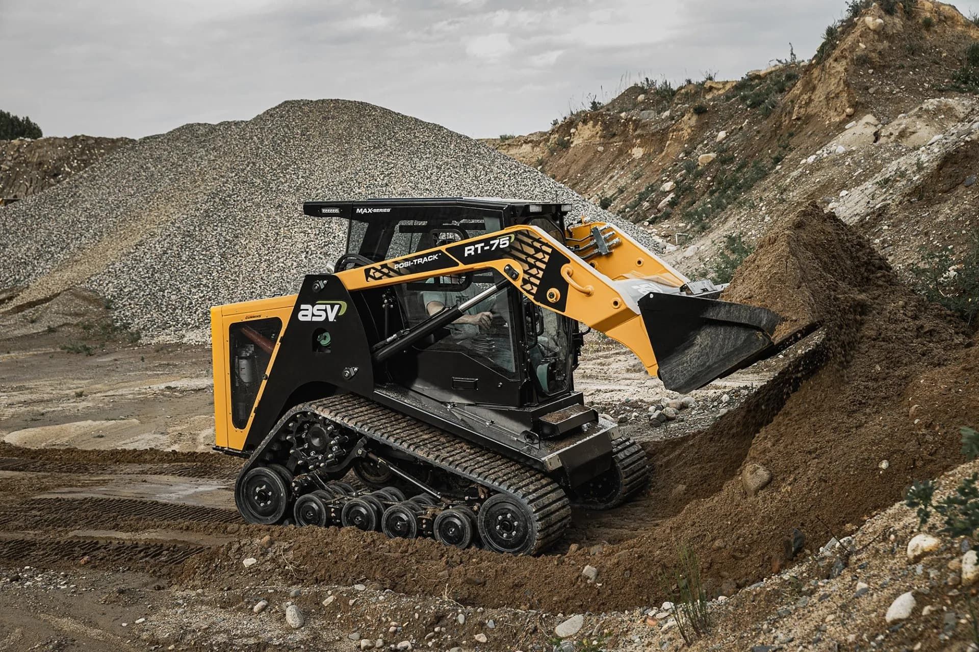 Yellow and Black Track Loader Digging Into a Pile of Dirt — Forecast Machinery in Yarrawonga, NT
