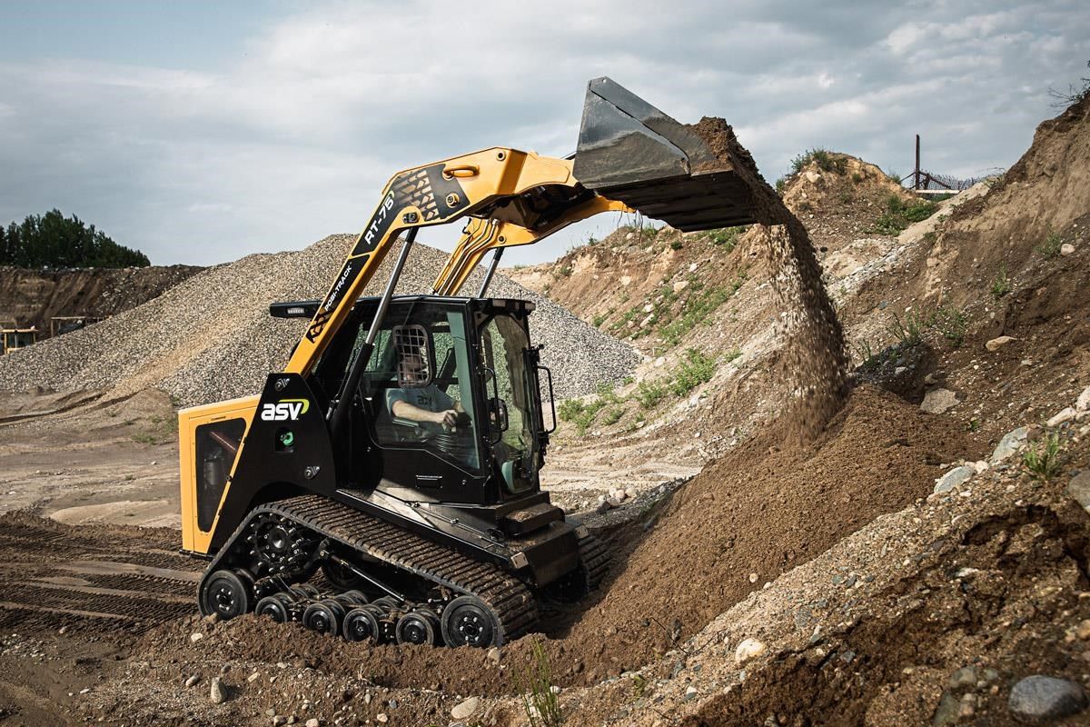Yellow and black ASV RT-65 compact track loader with a bucket attachment, on a white background — Forecast Machinery in Yarrawonga, NT