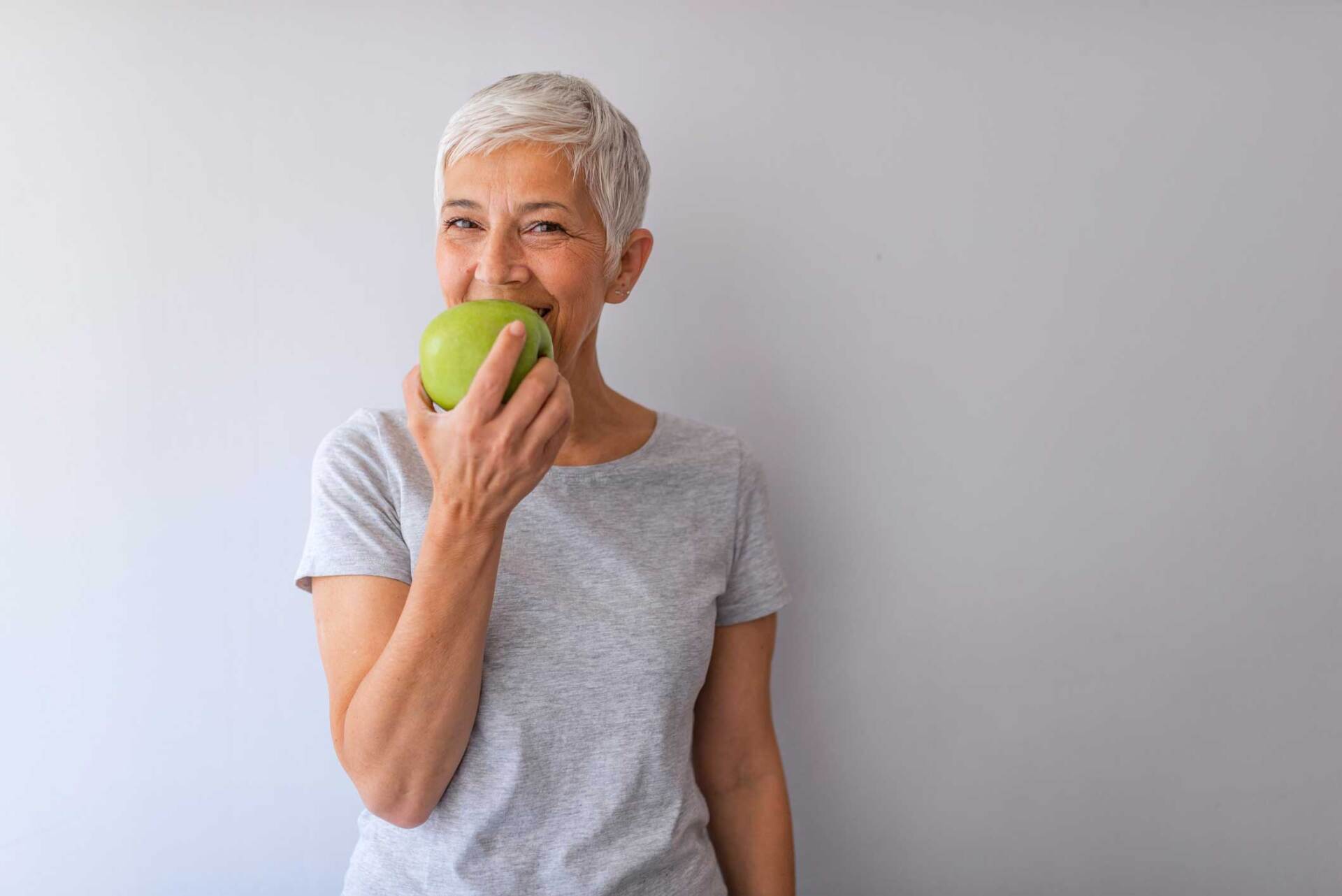 Woman Eating An Apple — Jacksonville, FL | Fulton Gibbs Wellness