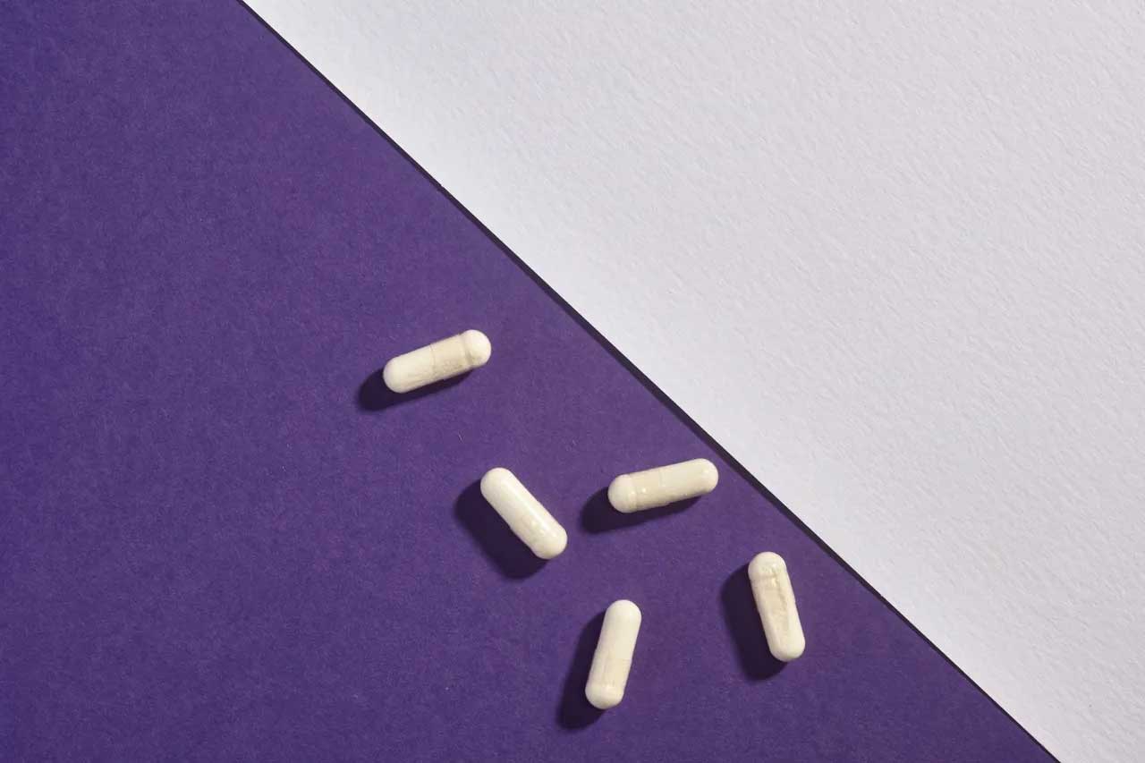 Pills On Purple Surface — Jacksonville, FL | Fulton Gibbs Wellness