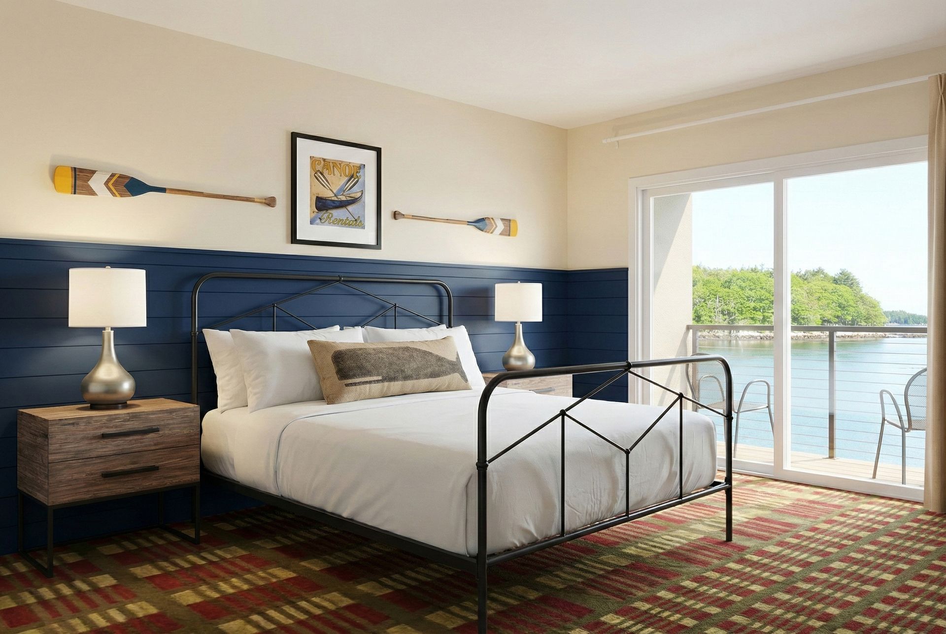 Bedroom with bed, nightstands, wall decor, and a sliding door leading to a balcony overlooking water.