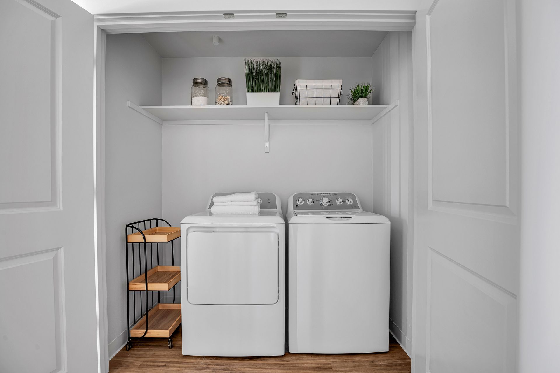 A laundry room with a washer and dryer in a closet.