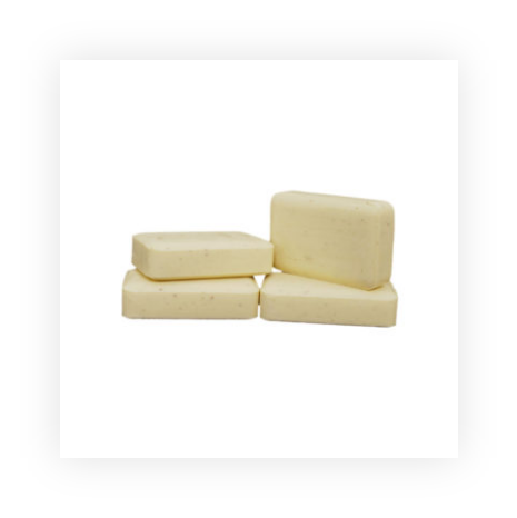 Four pieces of white soap are stacked on top of each other on a white background.