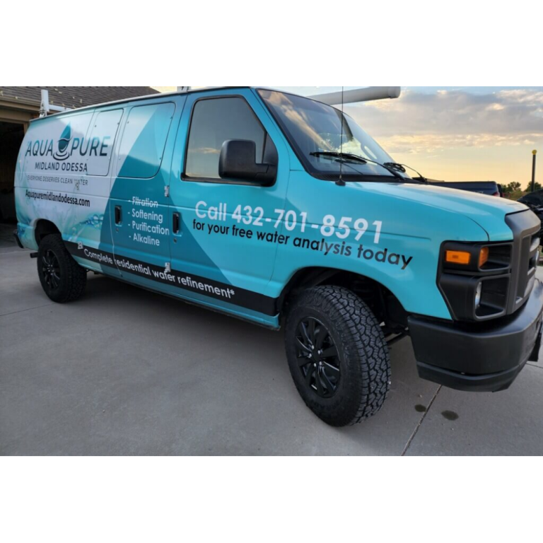 A blue aqua pure van is parked in a driveway