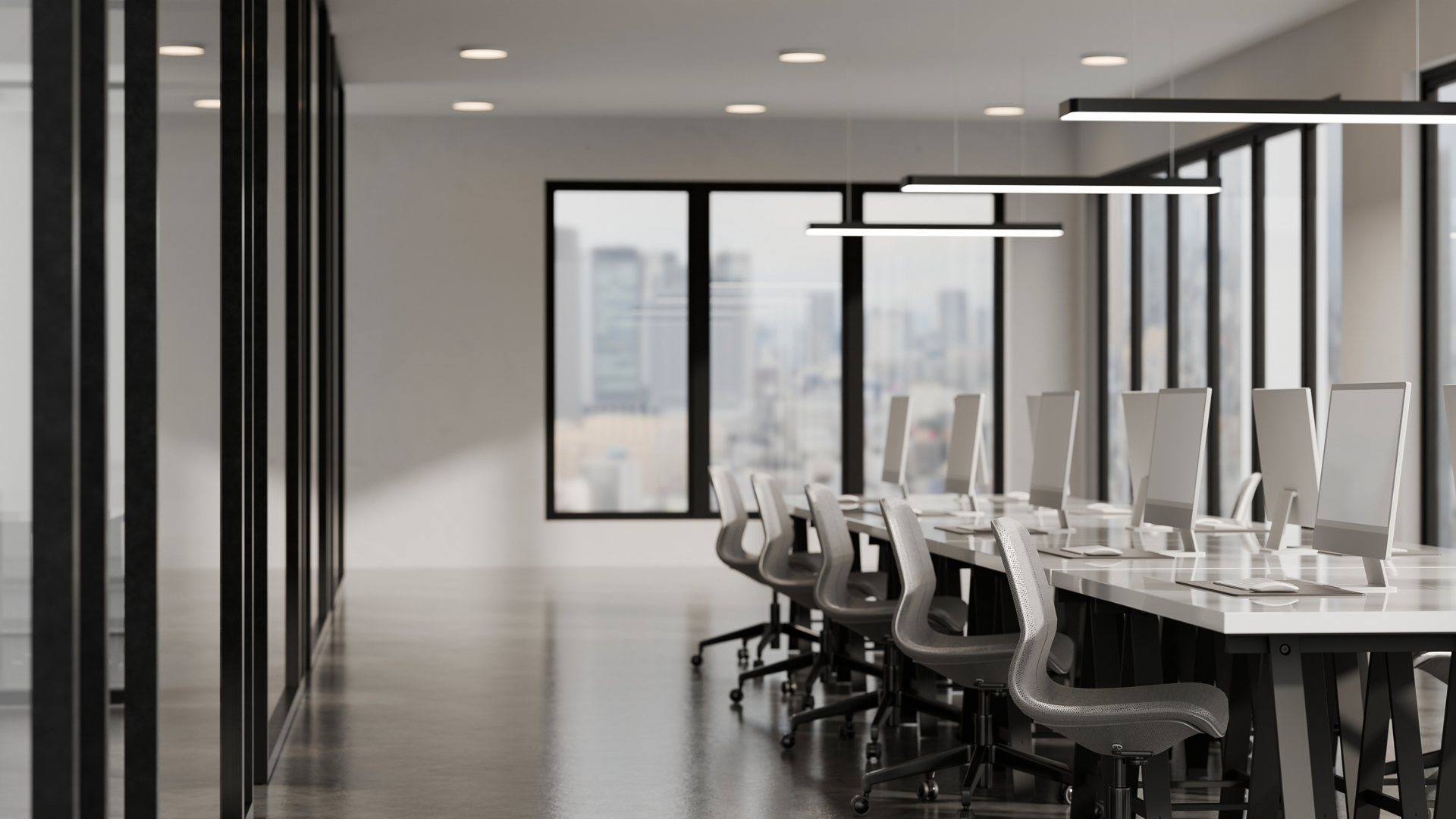 Modern conference room with a long table, office chairs, and city views through large windows