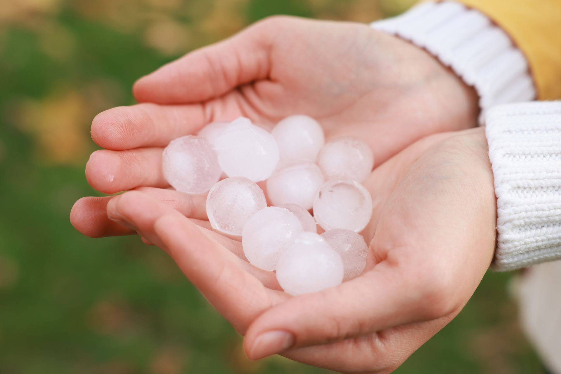 a person is holding a pile of hail in their hands