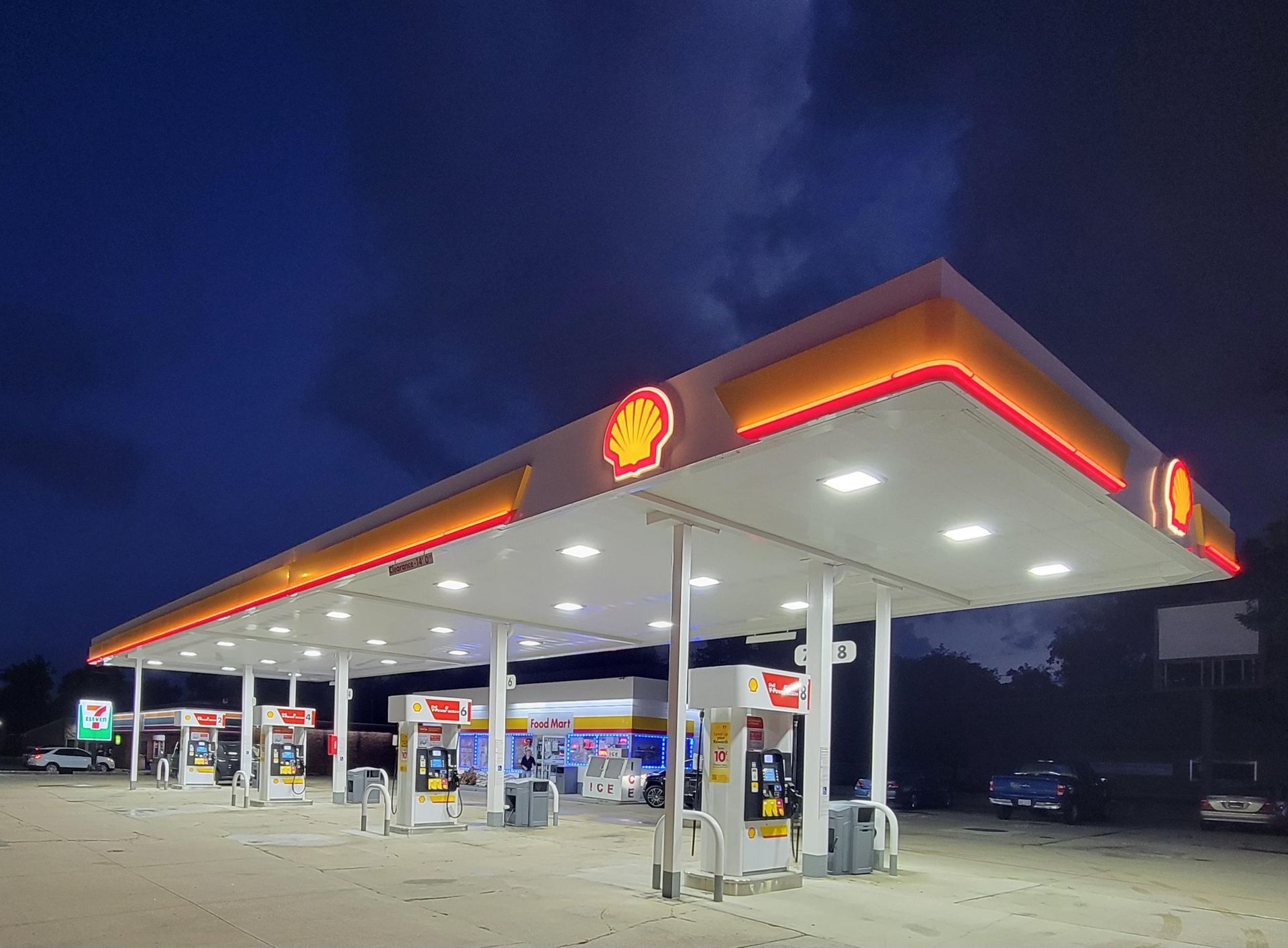 A shell gas station is lit up at night
