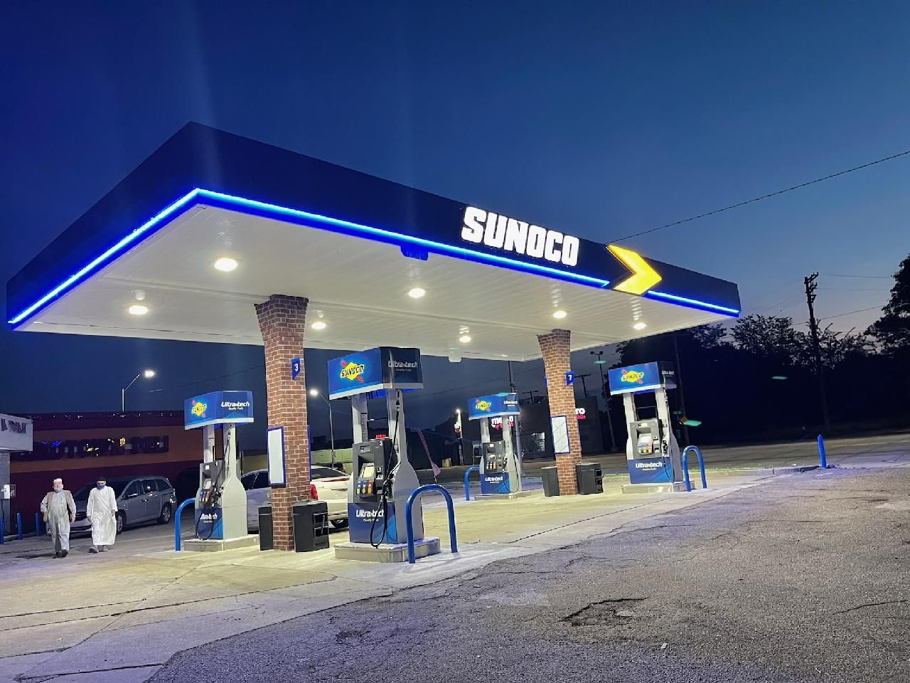 A sunoco gas station is lit up at night