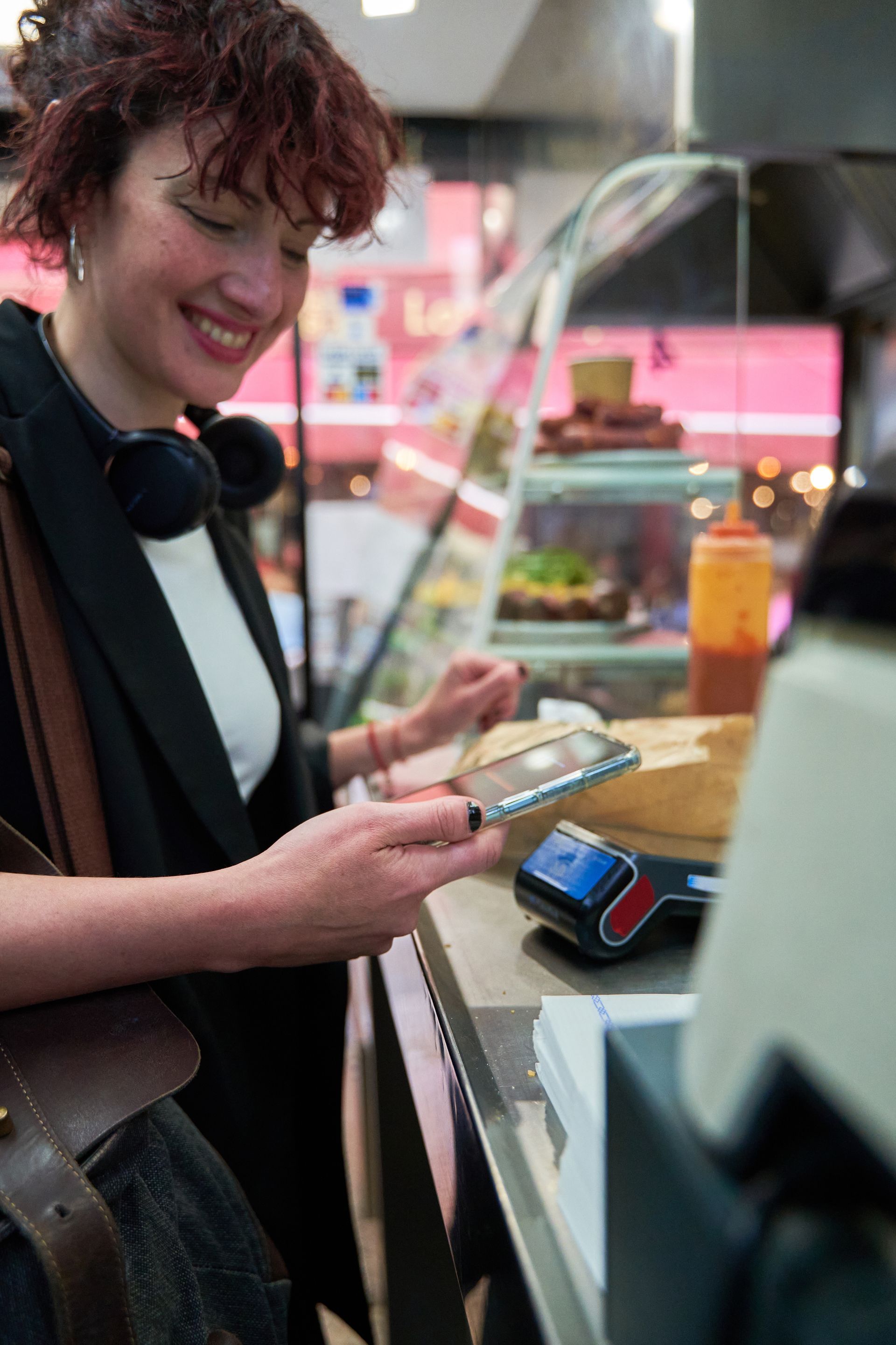 Women using phone at cash register