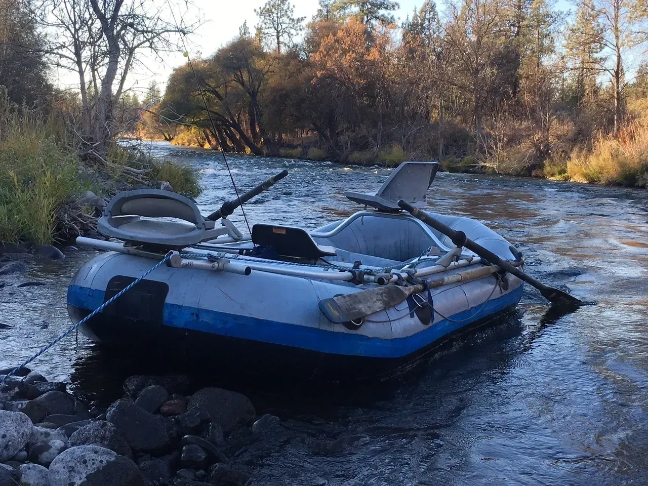 A raft is sitting in the middle of a river.