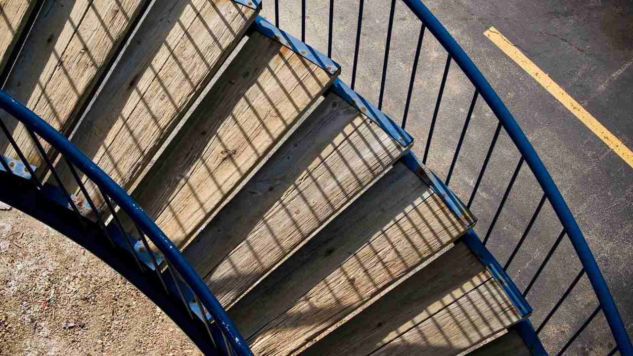 Blue spiral staircase with elegant railings.