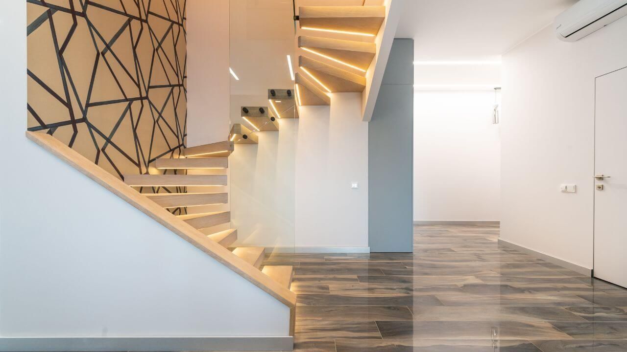 Stylish home staircase with wood and natural light.