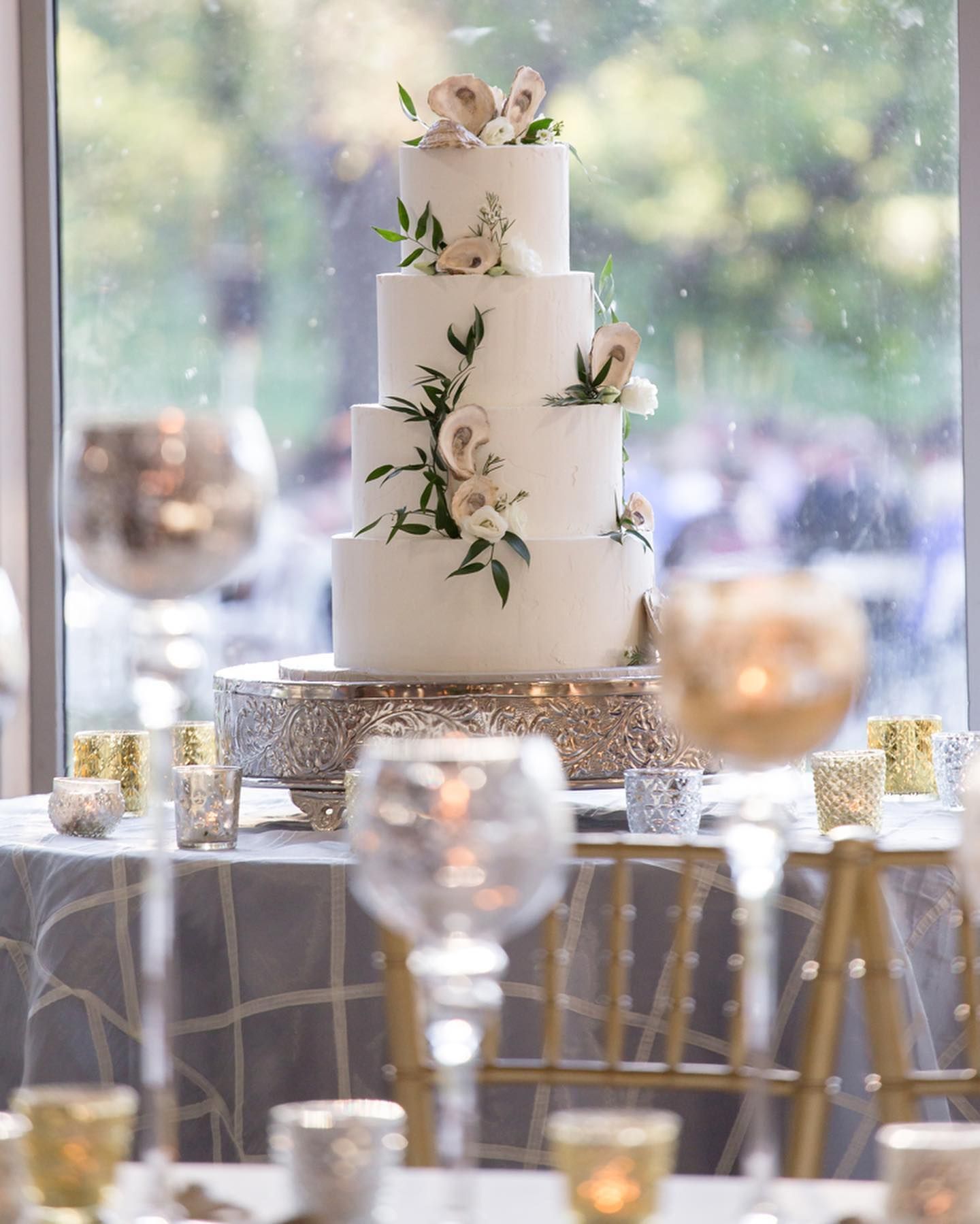 A large room filled with tables and chairs and a chandelier.