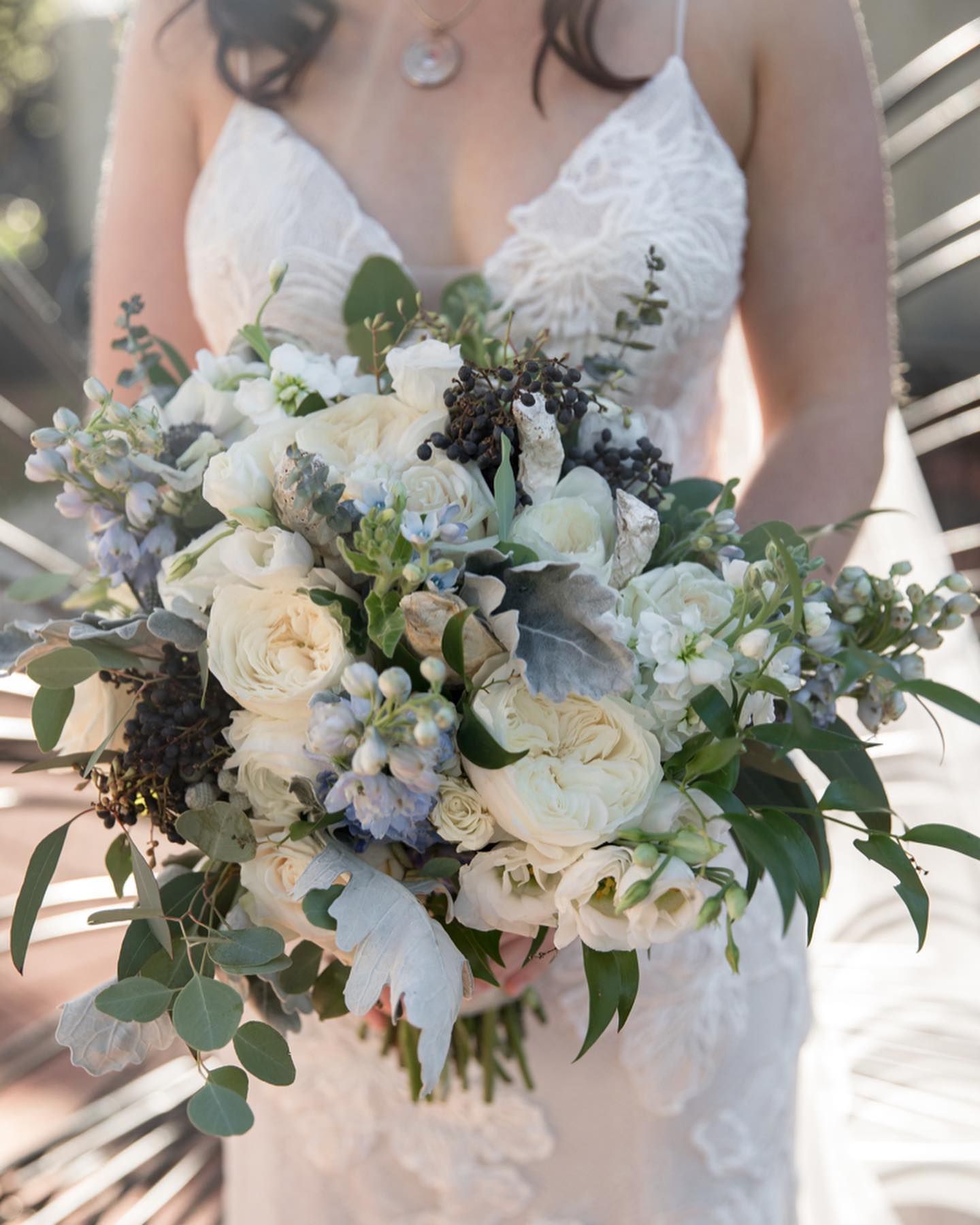 A large room filled with tables and chairs and a chandelier.