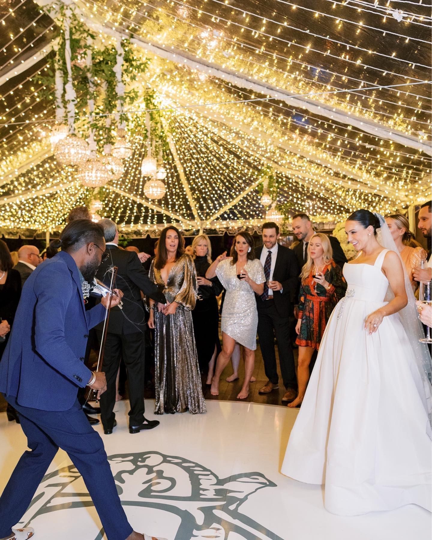 A large room filled with tables and chairs and a chandelier.