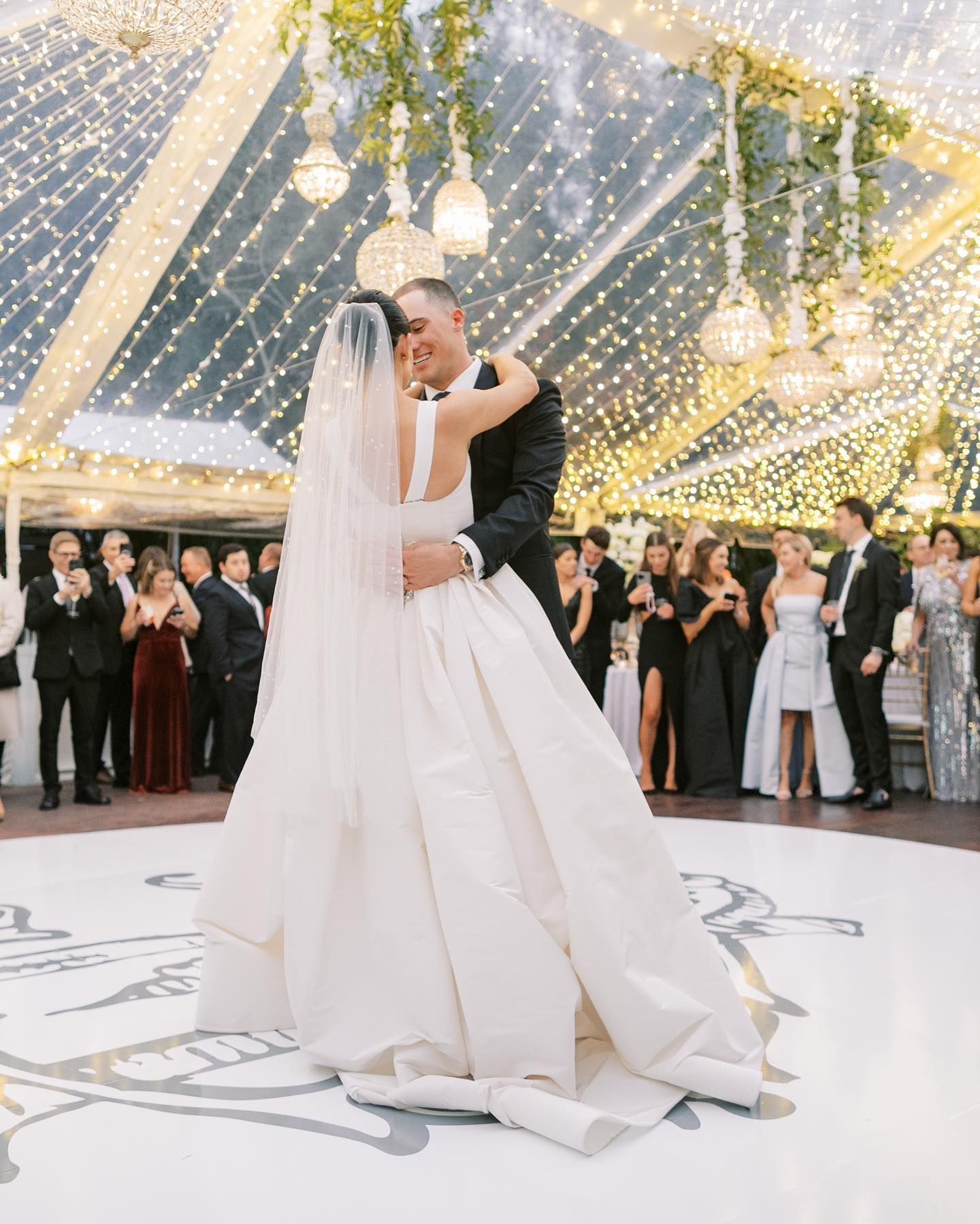 A large room filled with tables and chairs and a chandelier.