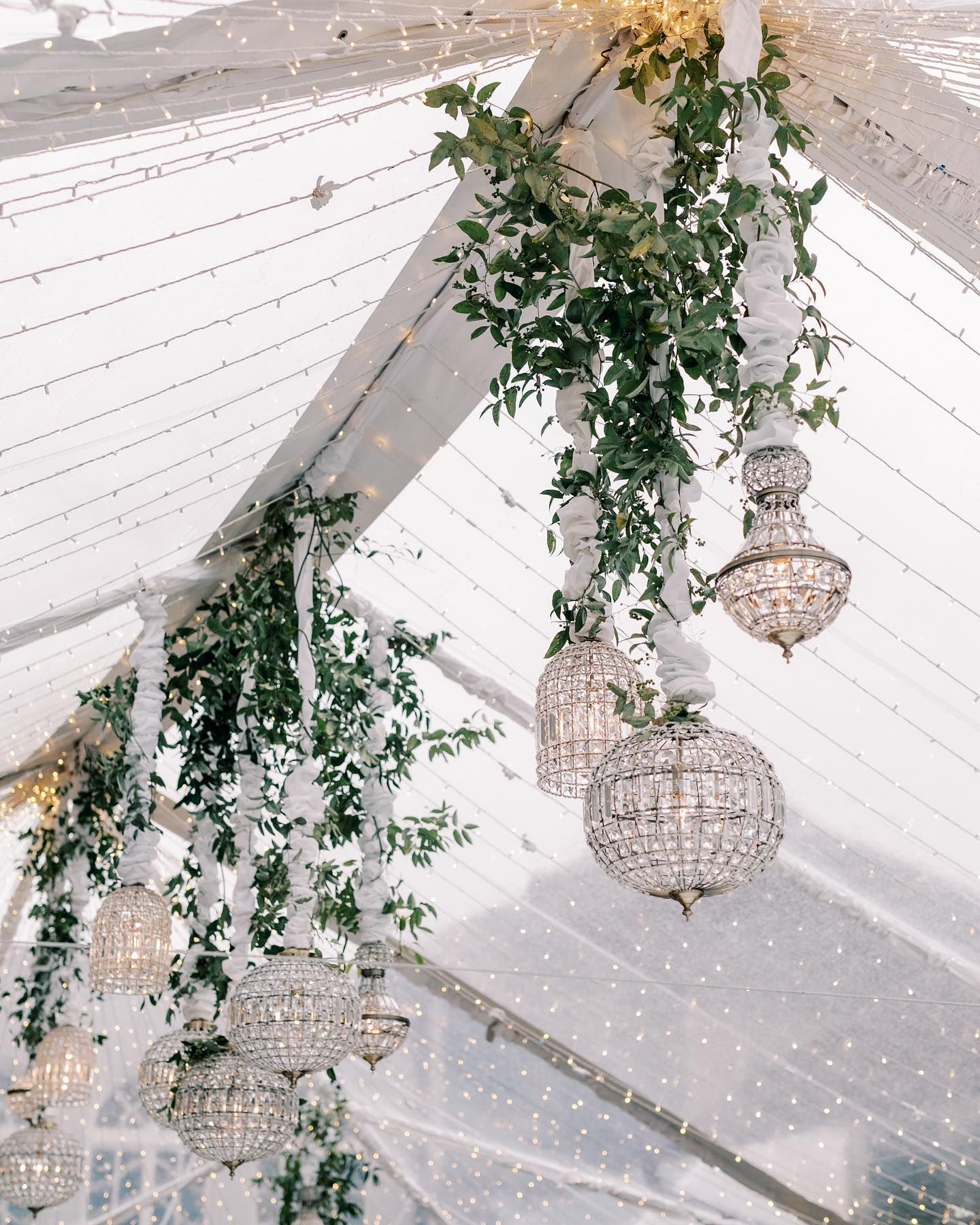 A large room filled with tables and chairs and a chandelier.
