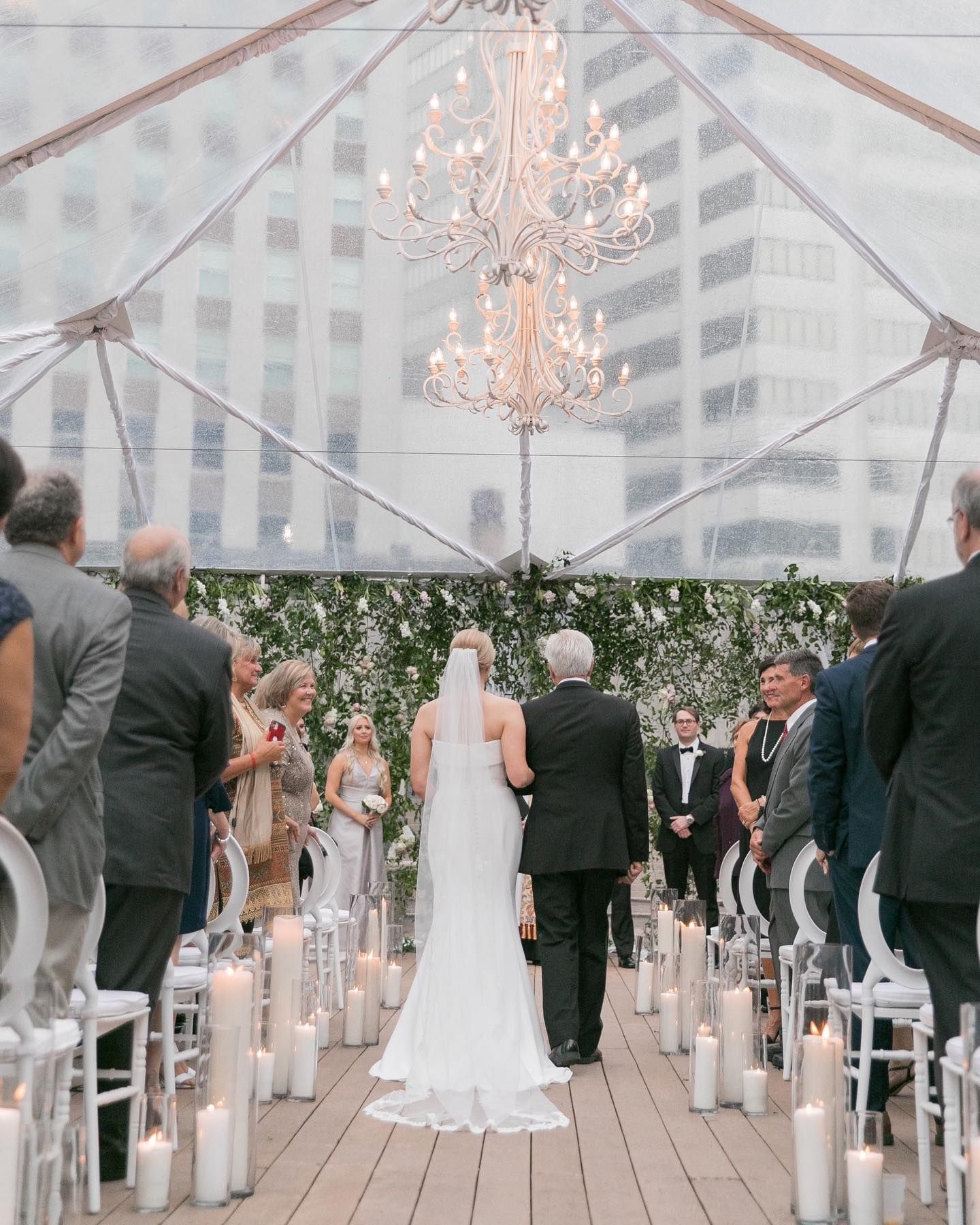 A large room filled with tables and chairs and a chandelier.