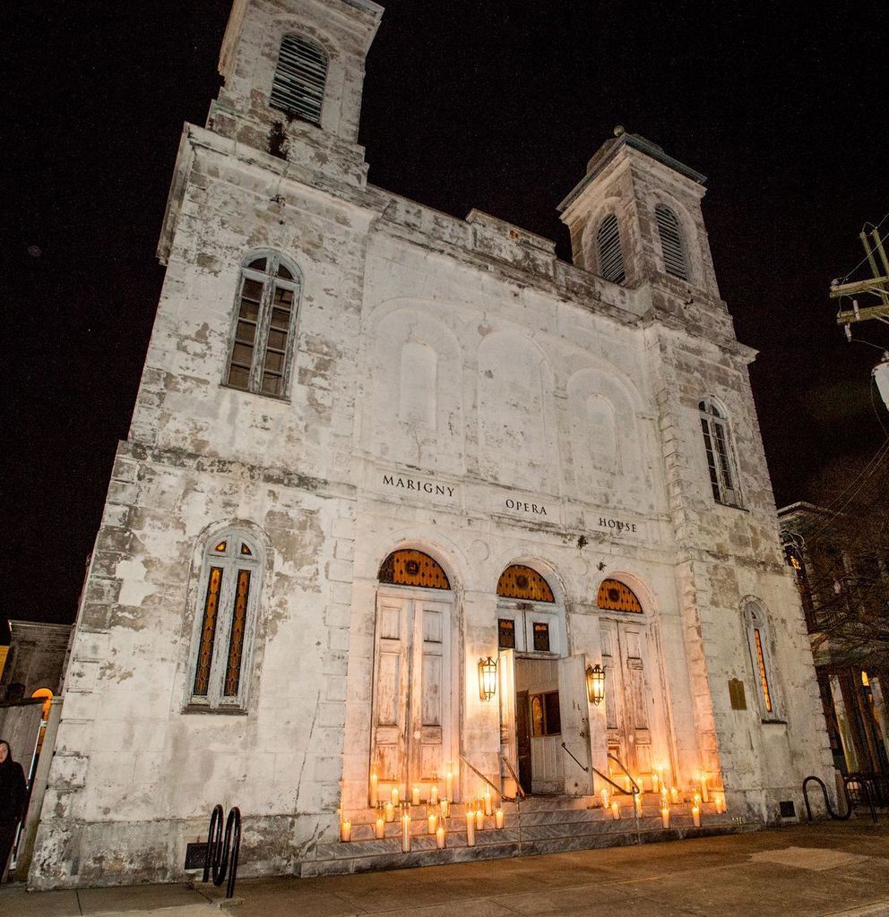 A large white building with candles lit up in front of it