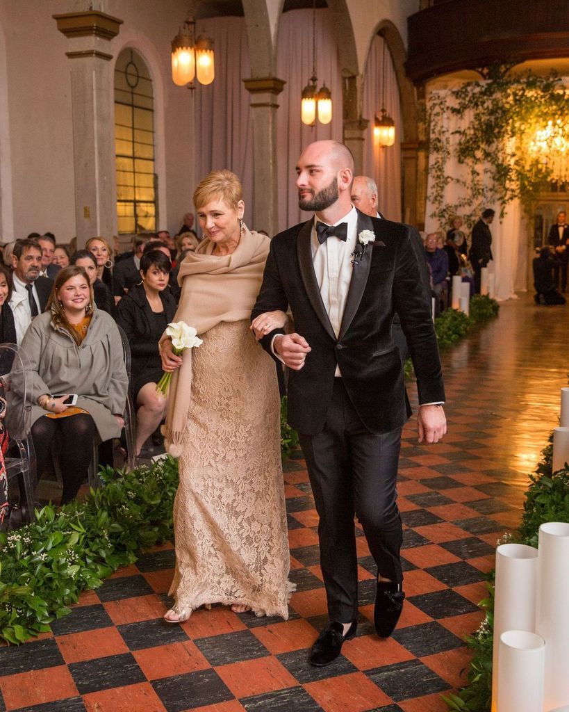 A bride and groom are walking down the aisle at a wedding.