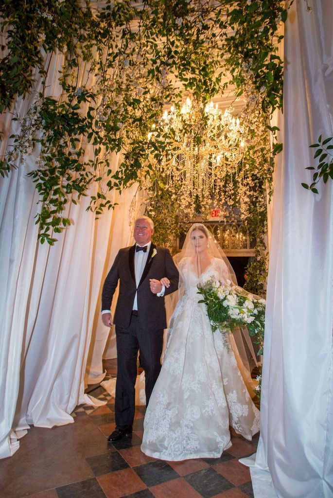 A bride and groom are walking down the aisle at their wedding.