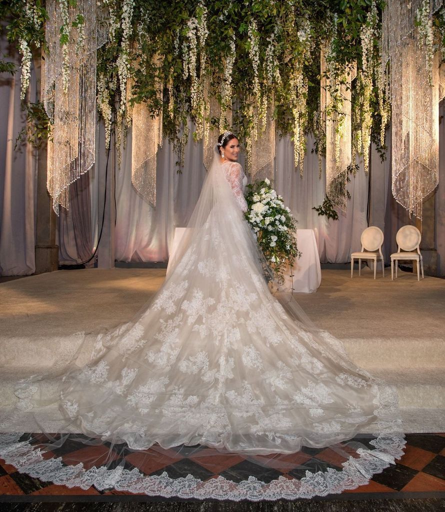 A woman in a wedding dress with a long train
